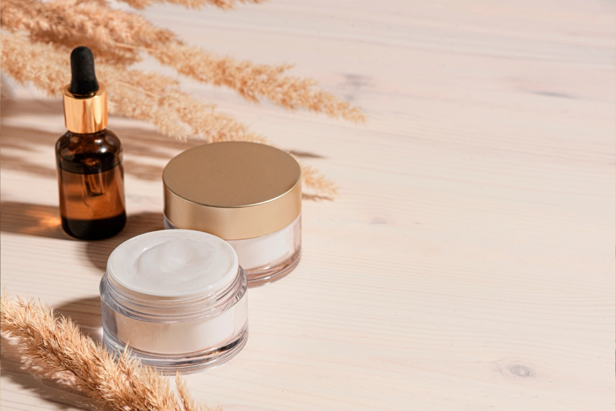 Cosmetic jars on wooden surface
